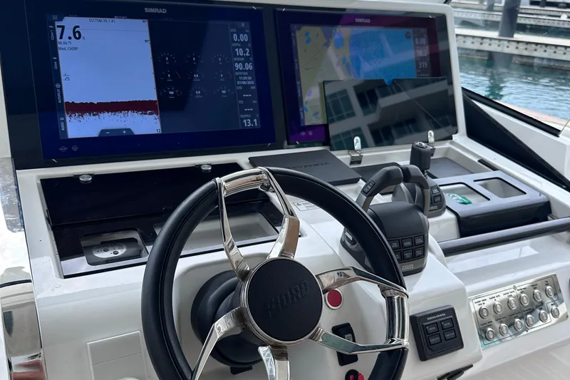 M2o Yacht Photos Pics 2024 Fjord 53 XL yacht dashboard with steering wheel and navigation screens.