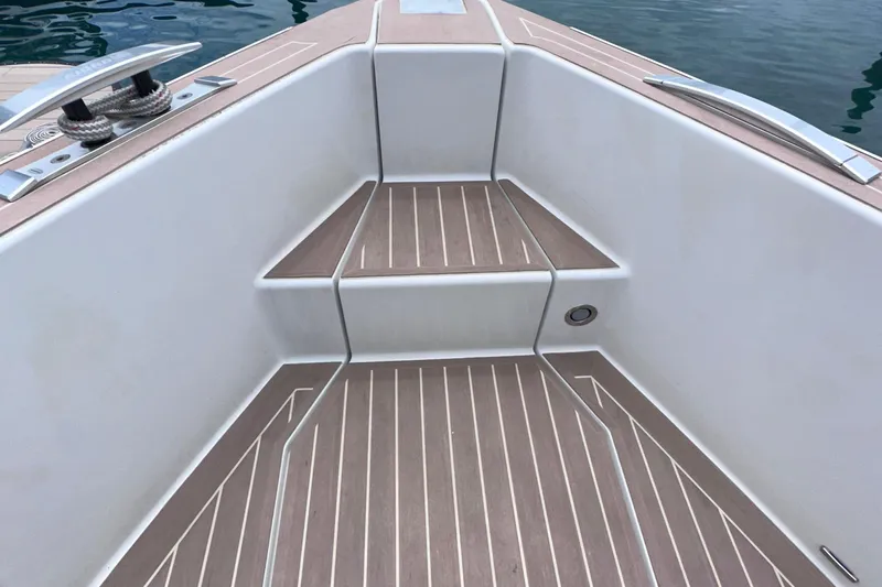 M2o Yacht Photos Pics 2024 Fjord 53 XL boat deck with sleek wooden steps and metal cleats.
