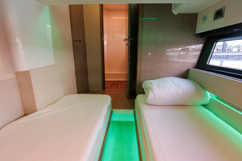 M2o Yacht Photos Pics 2024 Fjord 53 XL yacht interior with twin beds, modern design, and ambient lighting.