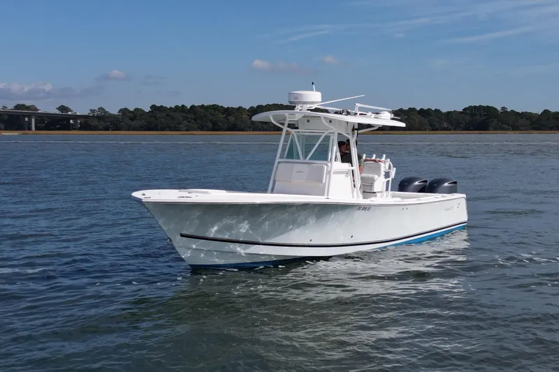  Yacht Photos Pics 2008 Regulator 32 Forward Seating boat cruising on calm waters.