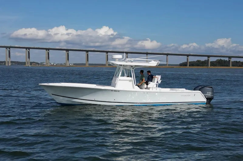  Yacht Photos Pics 2008 Regulator 32 Forward Seating boat on water with bridge in background.