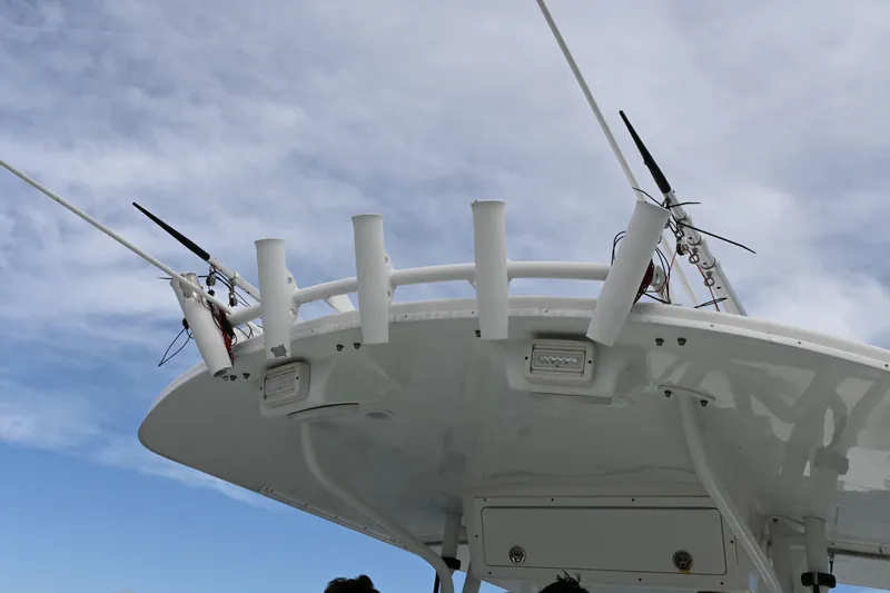  Yacht Photos Pics 2008 Regulator 32 Forward Seating boat with antennas and rod holders against a cloudy sky.