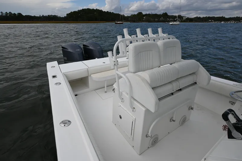  Yacht Photos Pics 2008 Regulator 32 Forward Seating boat on water, featuring dual engines and white seating.