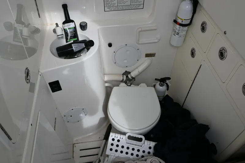  Yacht Photos Pics 2008 Regulator 32 Forward Seating boat bathroom with toilet, sink, and fire extinguisher.