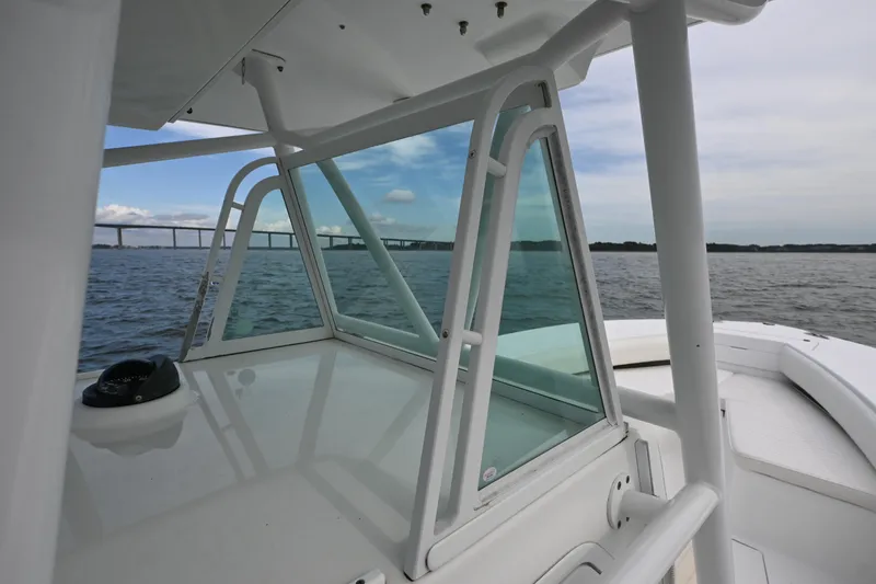  Yacht Photos Pics 2008 Regulator 32 Forward Seating boat on water, bridge in background.