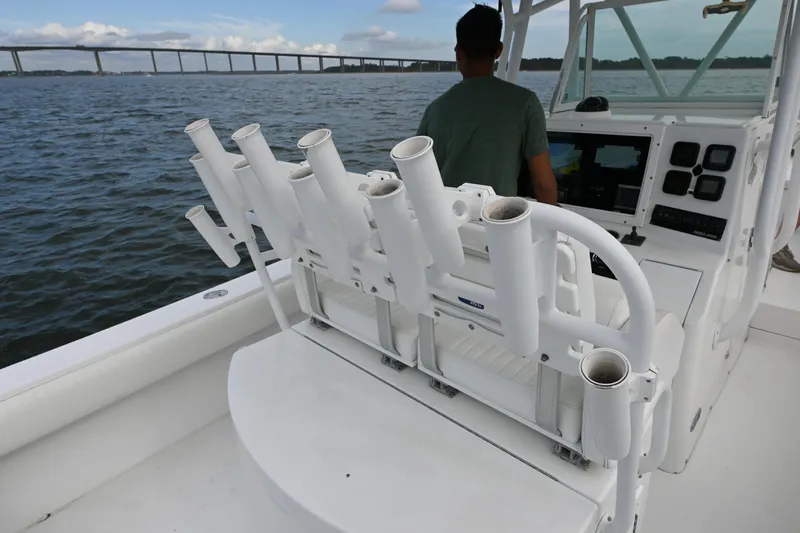  Yacht Photos Pics 2008 Regulator 32 Forward Seating boat with rod holders, on water near a bridge.