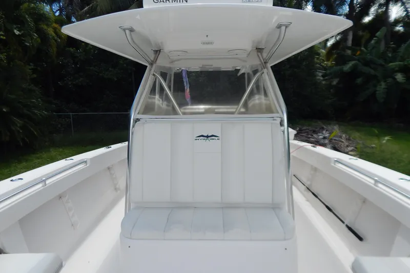  Yacht Photos Pics 2013 Invincible 42 Open Fisherman boat with white seating and canopy.