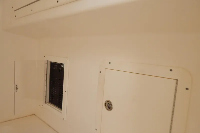 Yacht Photos Pics Electrical panel inside 2013 Invincible 42 Open Fisherman boat, featuring white interior.