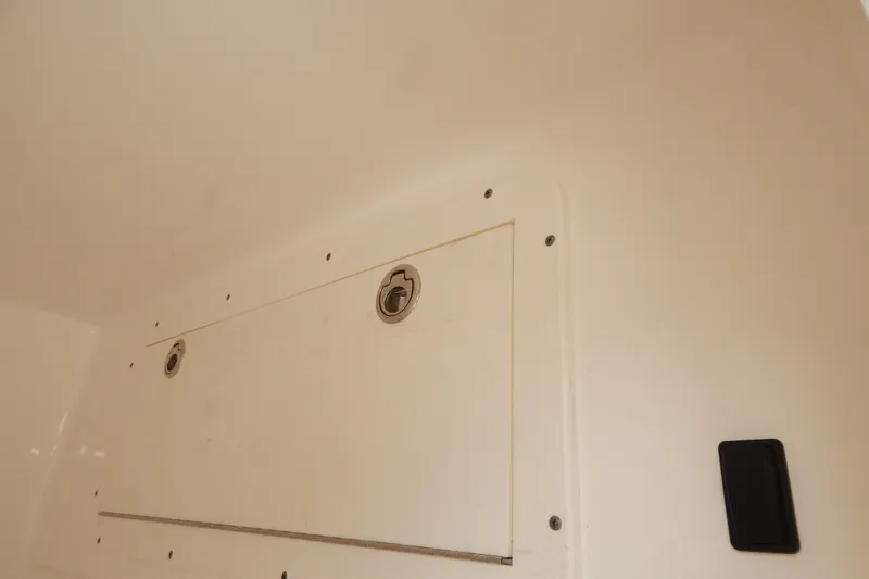  Yacht Photos Pics Interior compartment of 2013 Invincible 42 Open Fisherman boat, featuring secure latches.
