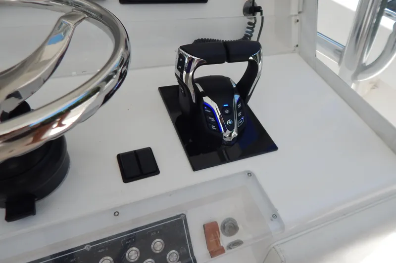  Yacht Photos Pics Control panel of 2013 Invincible 42 Open Fisherman boat with steering wheel and throttle.