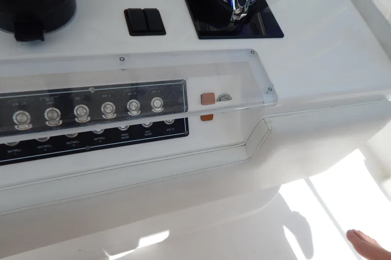 Yacht Photos Pics Control panel of a 2013 Invincible 42 Open Fisherman boat, featuring various switches.