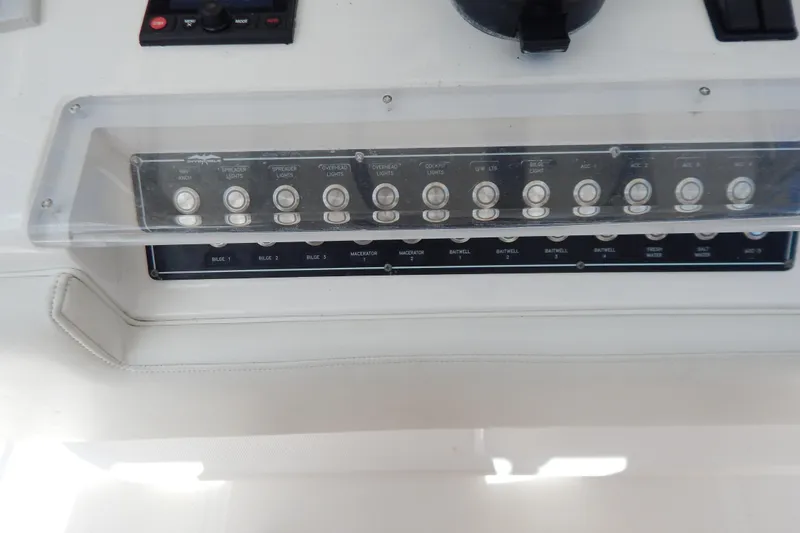  Yacht Photos Pics Control panel of a 2013 Invincible 42 Open Fisherman boat with labeled switches.