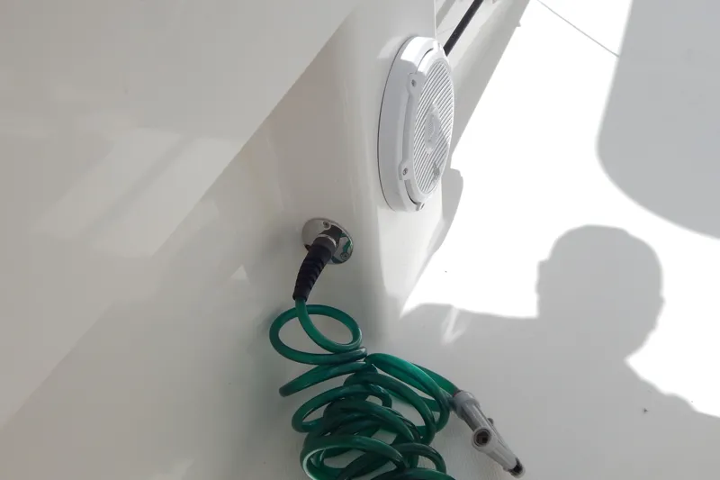  Yacht Photos Pics Coiled green hose and speaker on 2013 Invincible 42 Open Fisherman boat.