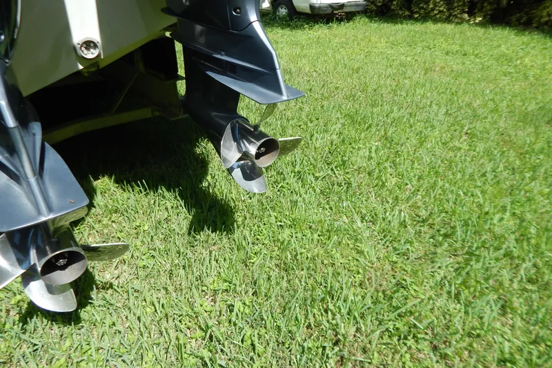  Yacht Photos Pics Propellers of a 2013 Invincible 42 Open Fisherman boat on grass.