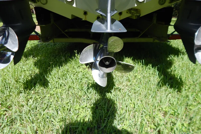  Yacht Photos Pics Propellers of a 2013 Invincible 42 Open Fisherman boat on grass.