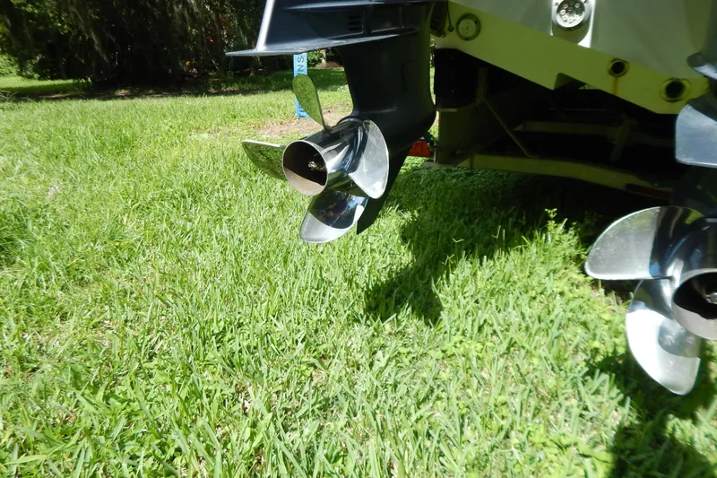  Yacht Photos Pics Propellers of a 2013 Invincible 42 Open Fisherman boat on grass.