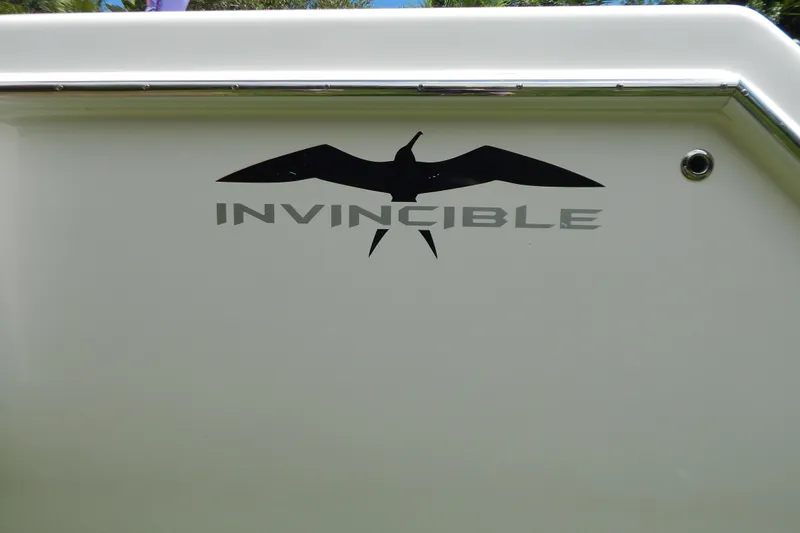  Yacht Photos Pics Invincible 42 Open Fisherman 2013 boat logo with bird silhouette on white surface.
