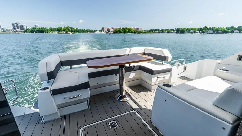 Belle Yacht Photos Pics 2018 Cruisers Yachts 50 Cantius deck with seating, table, and scenic water view.
