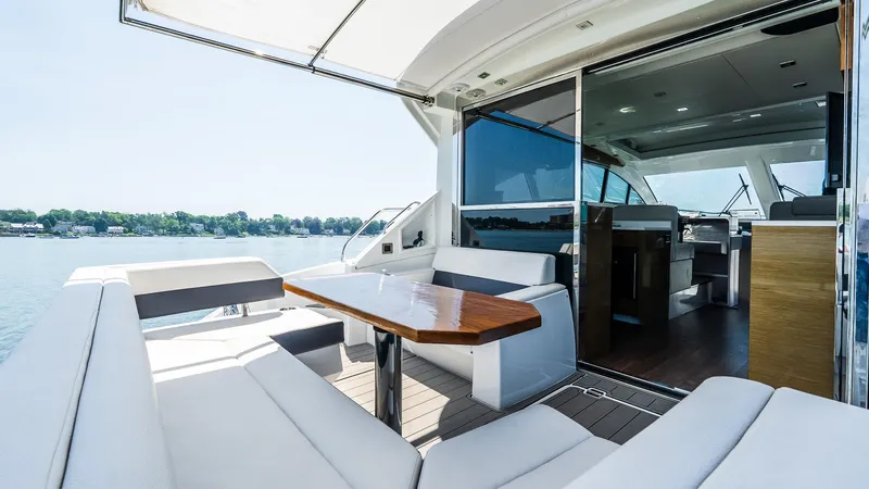 Belle Yacht Photos Pics 2018 Cruisers Yachts 50 Cantius with elegant outdoor seating and scenic water view.