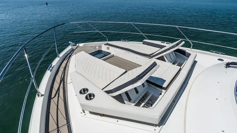 Belle Yacht Photos Pics Luxurious 2018 Cruisers Yachts 50 Cantius with sun loungers on deck, overlooking serene waters.