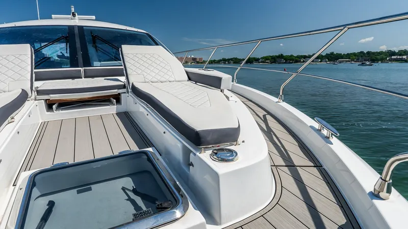 Belle Yacht Photos Pics Luxurious 2018 Cruisers Yachts 50 Cantius deck with plush seating, overlooking serene waters.