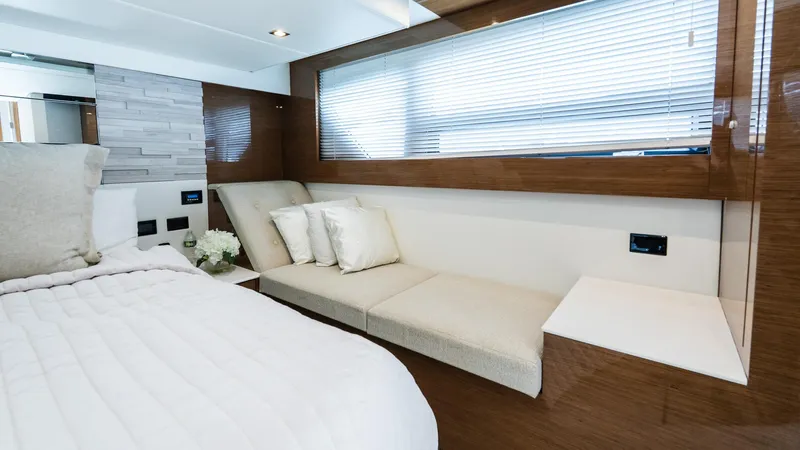 Belle Yacht Photos Pics Luxurious interior of 2018 Cruisers Yachts 50 Cantius with elegant bedding and seating.