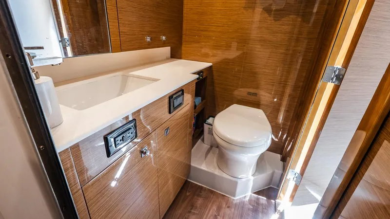 Belle Yacht Photos Pics Luxurious bathroom in 2018 Cruisers Yachts 50 Cantius with modern fixtures and wood finish.