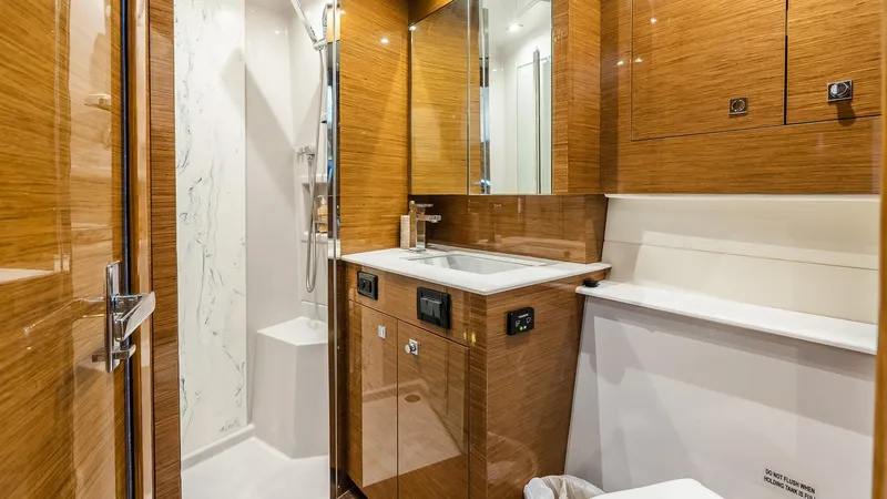 Belle Yacht Photos Pics Luxurious bathroom in 2018 Cruisers Yachts 50 Cantius with wood finish and modern fixtures.