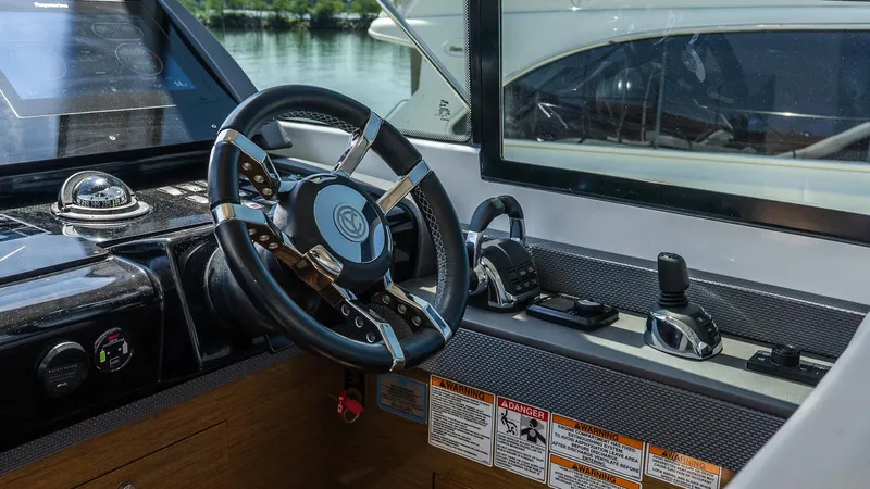 Belle Yacht Photos Pics 2018 Cruisers Yachts 50 Cantius helm with steering wheel and navigation controls.