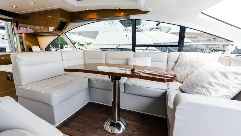 Belle Yacht Photos Pics Luxurious interior of 2018 Cruisers Yachts 50 Cantius with plush seating and elegant table.