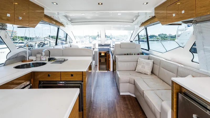 Belle Yacht Photos Pics Luxurious interior of 2018 Cruisers Yachts 50 Cantius with modern kitchen and seating area.