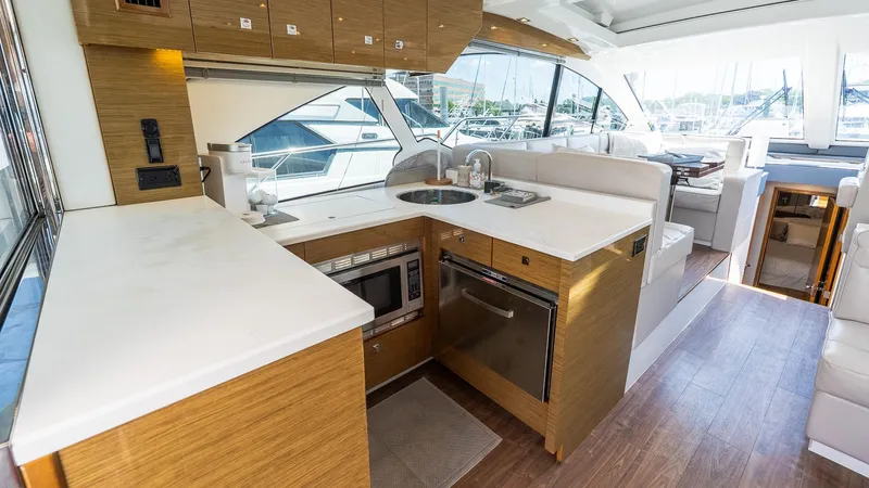 Belle Yacht Photos Pics Luxurious 2018 Cruisers Yachts 50 Cantius interior with modern kitchen and seating area.