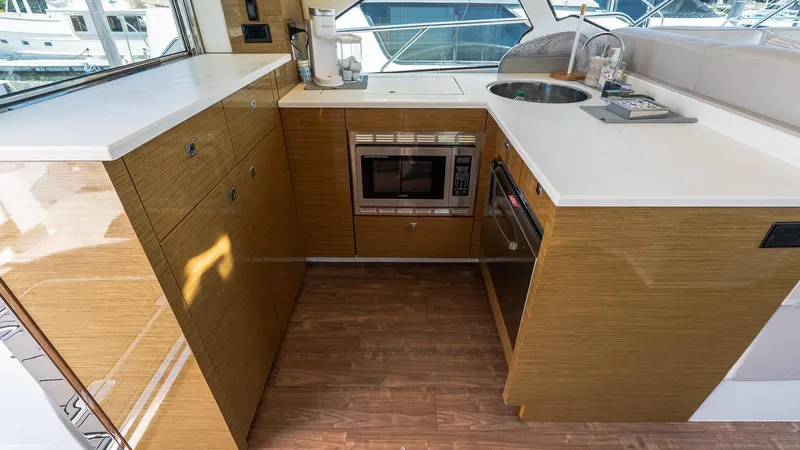 Belle Yacht Photos Pics Modern kitchen in 2018 Cruisers Yachts 50 Cantius with wood cabinetry and appliances.