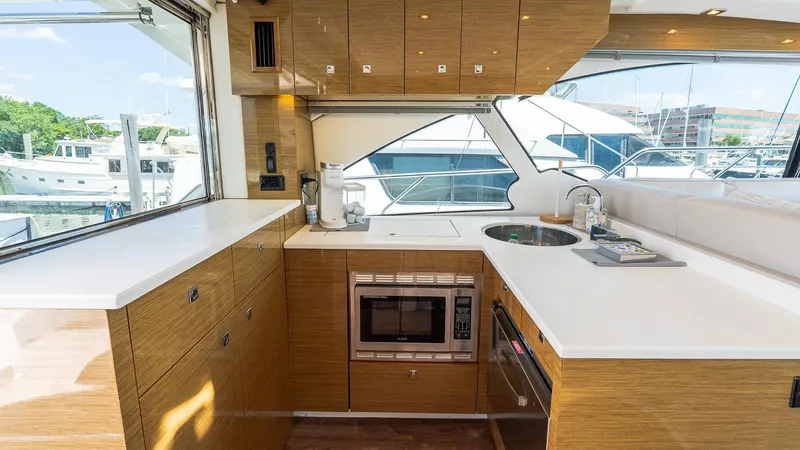 Belle Yacht Photos Pics Luxurious kitchen interior of 2018 Cruisers Yachts 50 Cantius with modern appliances.
