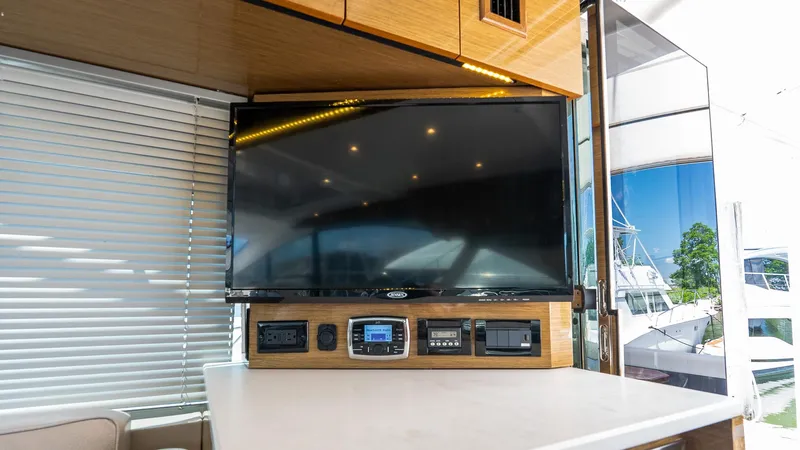Belle Yacht Photos Pics Interior of 2018 Cruisers Yachts 50 Cantius with TV and control panel.