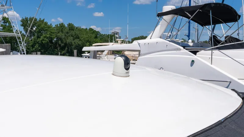 Belle Yacht Photos Pics 2018 Cruisers Yachts 50 Cantius on deck, featuring sleek design and clear blue sky.