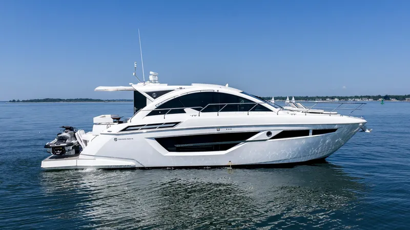 Belle Yacht Photos Pics 2018 Cruisers Yachts 50 Cantius on calm water under clear blue sky.