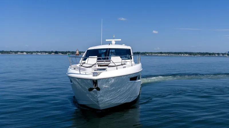 Belle Yacht Photos Pics 2018 Cruisers Yachts 50 Cantius on calm water under clear blue sky.