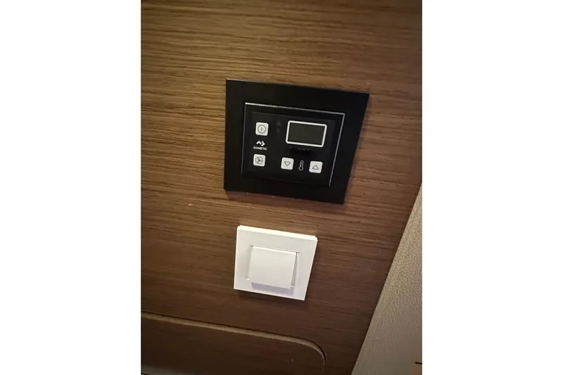 Bolubo Yacht Photos Pics Control panel and switch on Lagoon 42 yacht, 2019 model, wooden interior.