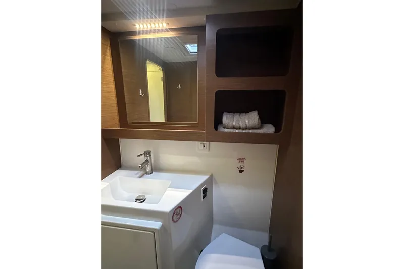 Bolubo Yacht Photos Pics Bathroom interior of 2019 Lagoon 42 yacht with sink, mirror, and shelves.