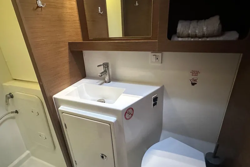 Bolubo Yacht Photos Pics Bathroom interior of 2019 Lagoon 42 yacht with sink and storage.