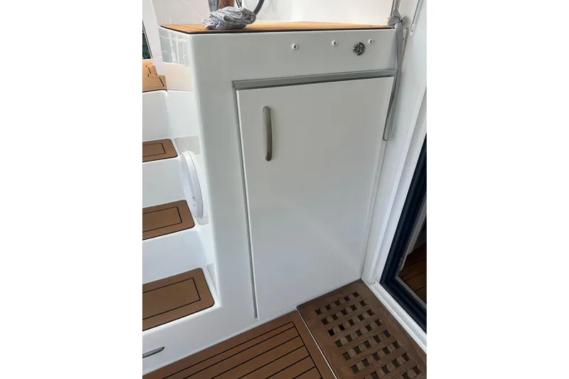 Bolubo Yacht Photos Pics 2019 Lagoon 42 yacht interior with sleek white cabinetry and wooden flooring.