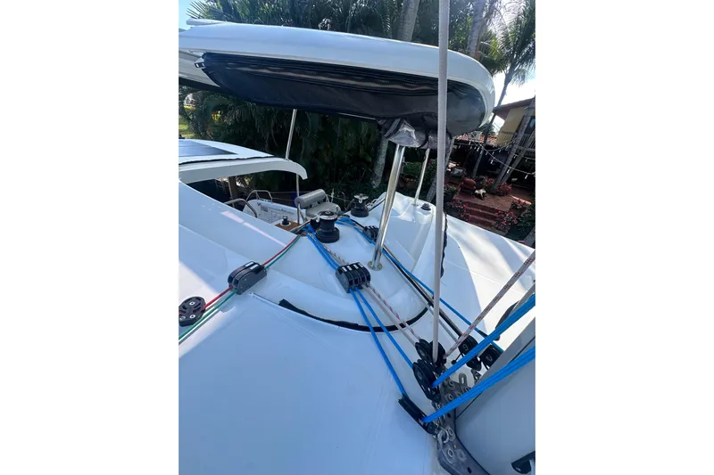 Bolubo Yacht Photos Pics 2019 Lagoon 42 sailboat deck with rigging and winches, surrounded by tropical foliage.