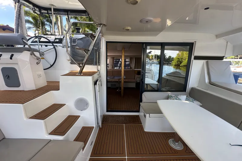 Bolubo Yacht Photos Pics Luxurious 2019 Lagoon 42 catamaran interior with helm, seating, and scenic water view.