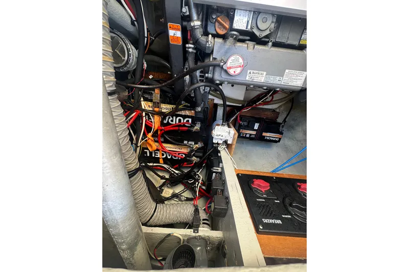 Bolubo Yacht Photos Pics Engine compartment of a 2019 Lagoon 42 catamaran with visible wiring and batteries.