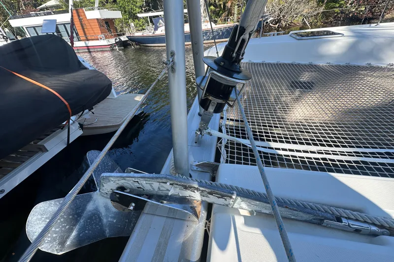 Bolubo Yacht Photos Pics 2019 Lagoon 42 catamaran deck with anchor and netting, docked by the water.