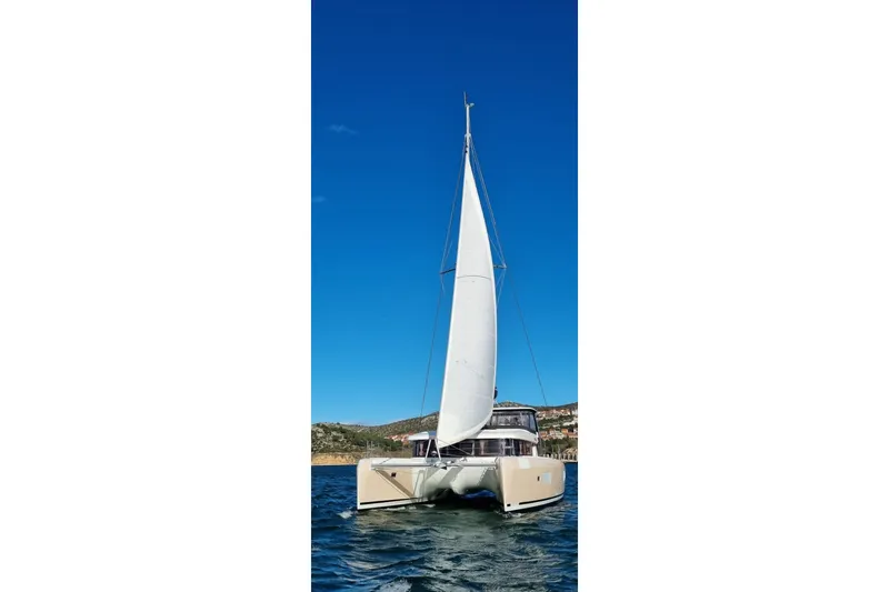 Bolubo Yacht Photos Pics 2019 Lagoon 42 catamaran sailing on clear blue waters under a bright sky.