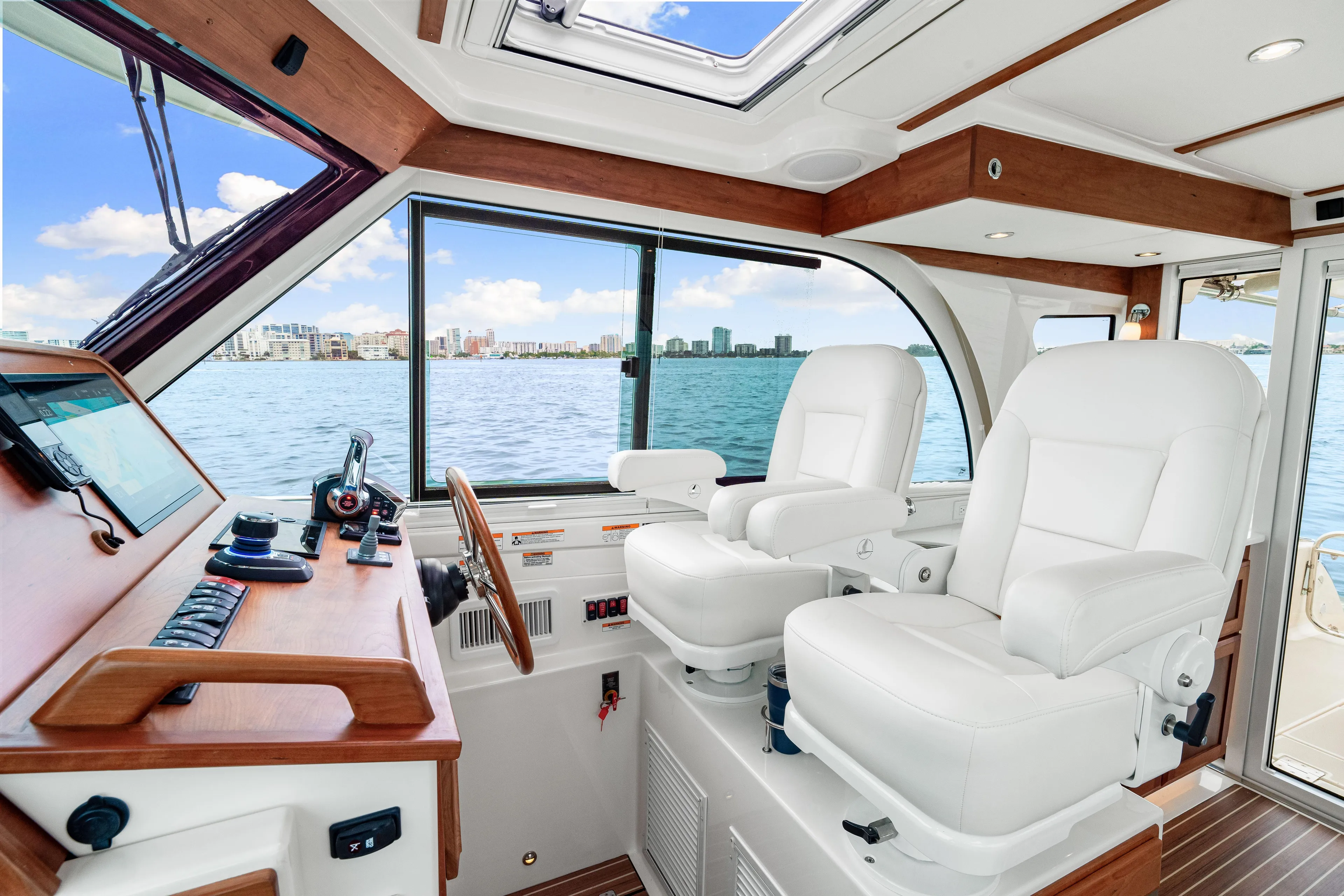  Yacht Photos Pics 2024 Back Cove 39O helm with luxurious white seating and panoramic ocean view.