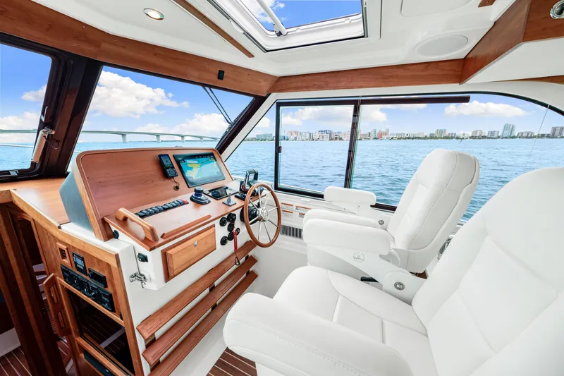  Yacht Photos Pics 2024 Back Cove 39O yacht interior with helm, luxurious seating, and ocean view.