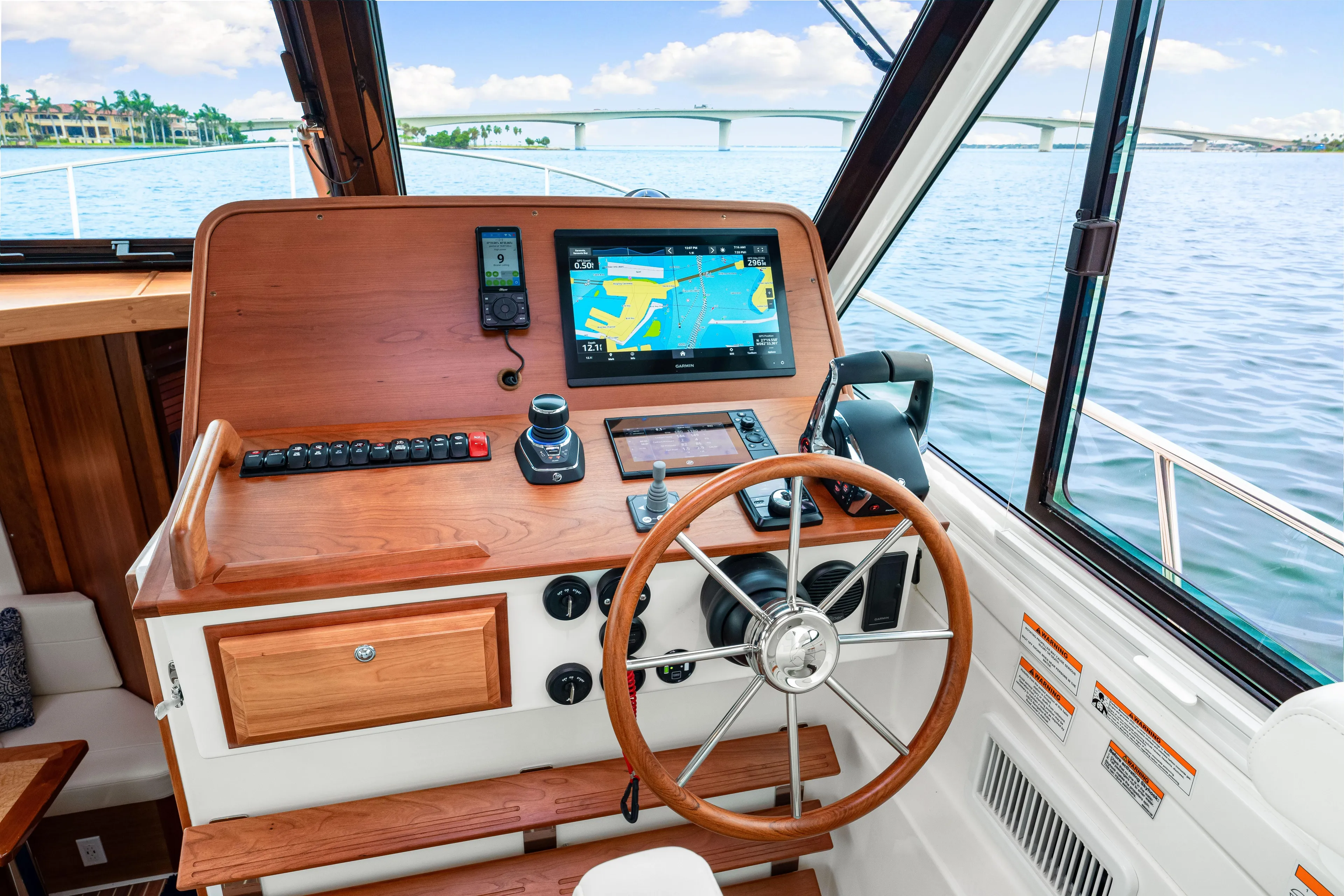  Yacht Photos Pics 2024 Back Cove 39O helm with wooden steering wheel and navigation display.